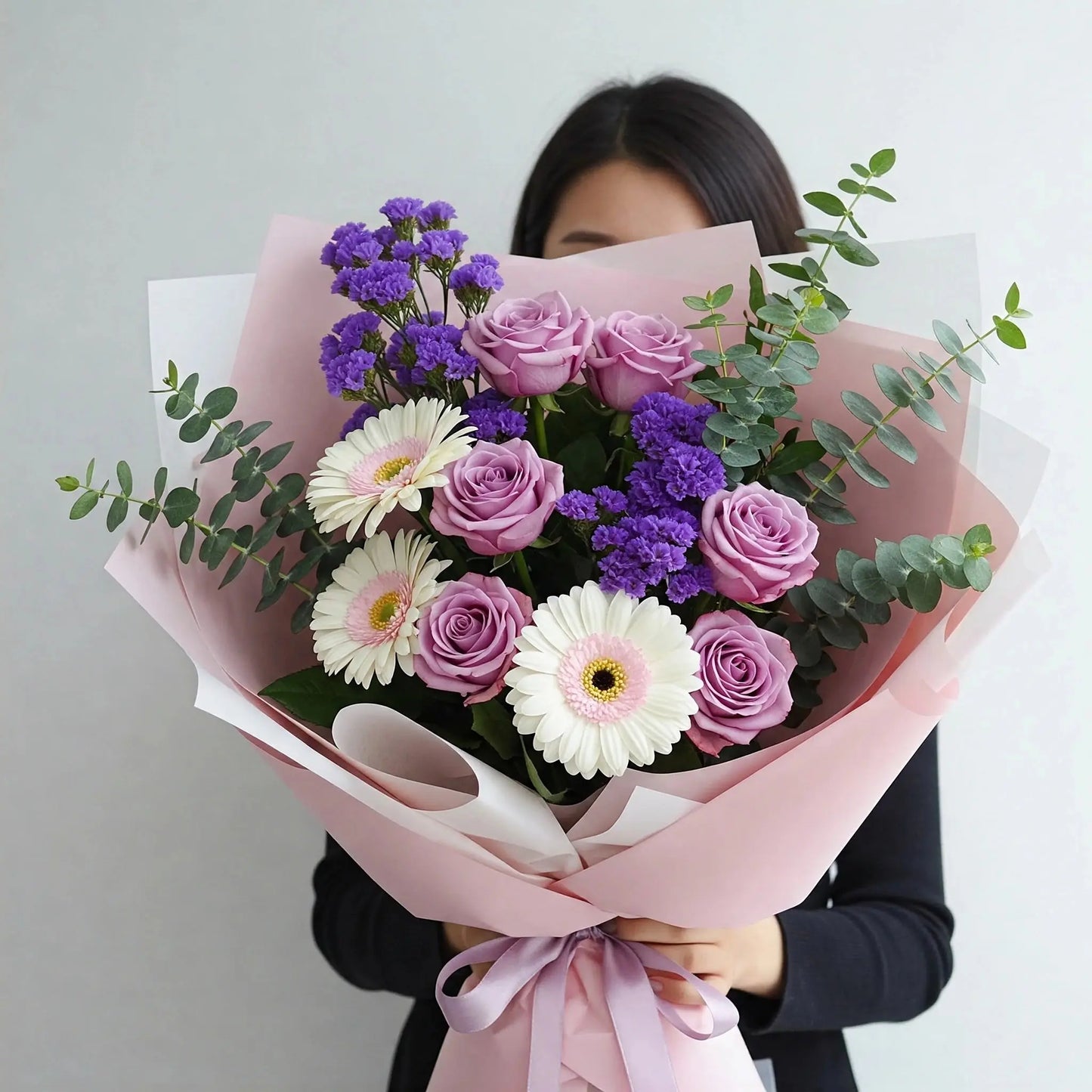 Elegant flower bouquet delivery Hong Kong featuring 6 purple roses, 3 white gerberas, purple statices, and eucalyptus leaves, wrapped in a stylish arrangement.