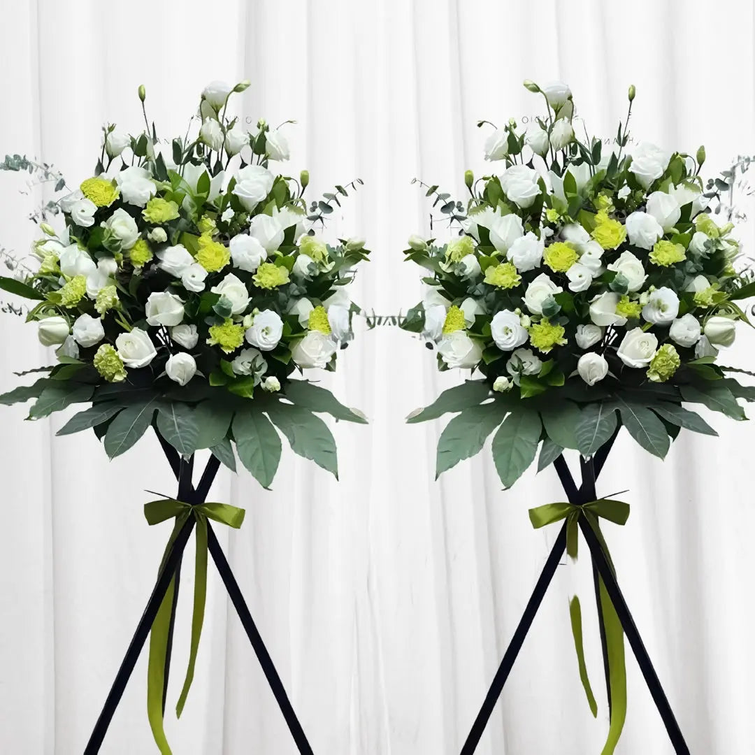 Majestic White & Green Bouquet with white roses, green carnations, and white lisianthus in a black stand with a green ribbon, ideal for formal events in Hong Kong.